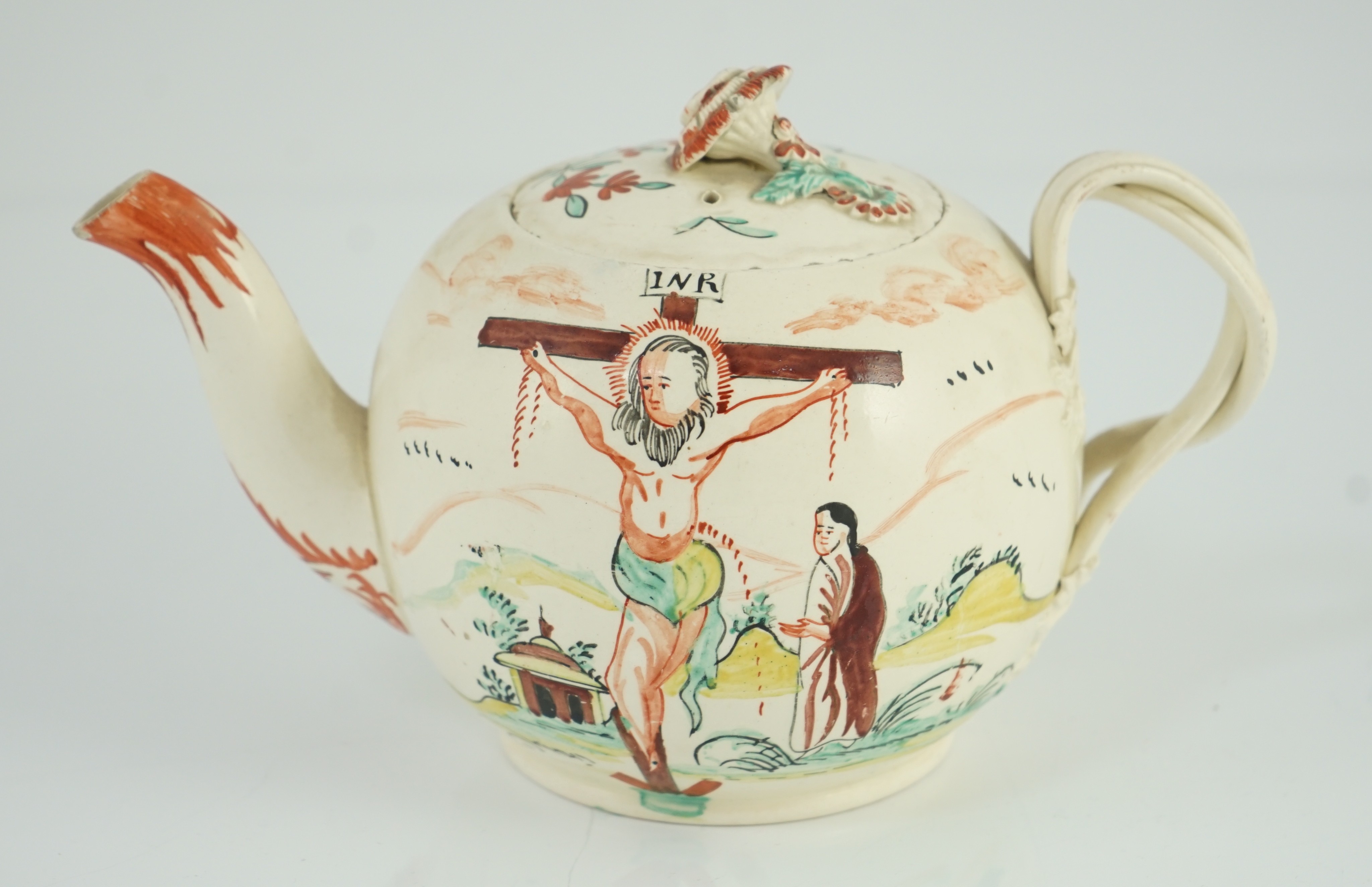 A rare English creamware ‘crucifixion’ teapot, c.1780-1800, 20cm spout to handle, tiny chips